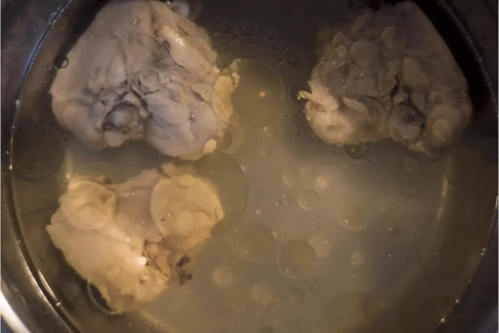 Homemade bone broth served in a bowl, with a layer of fat on the surface